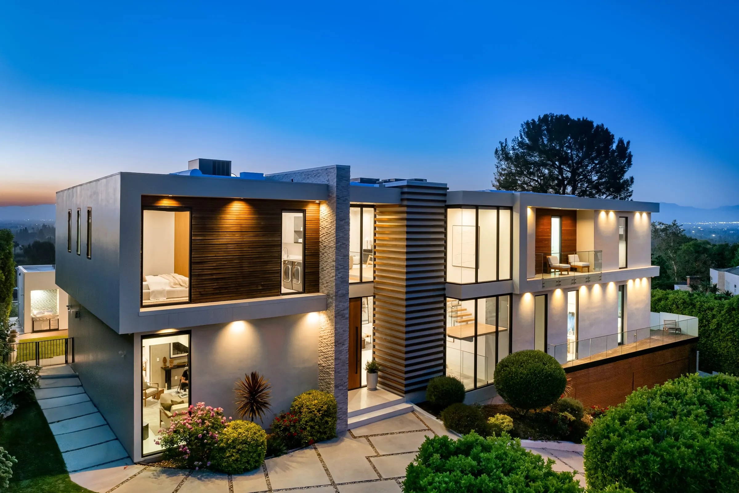 Villa exterior at dusk with warm interior light