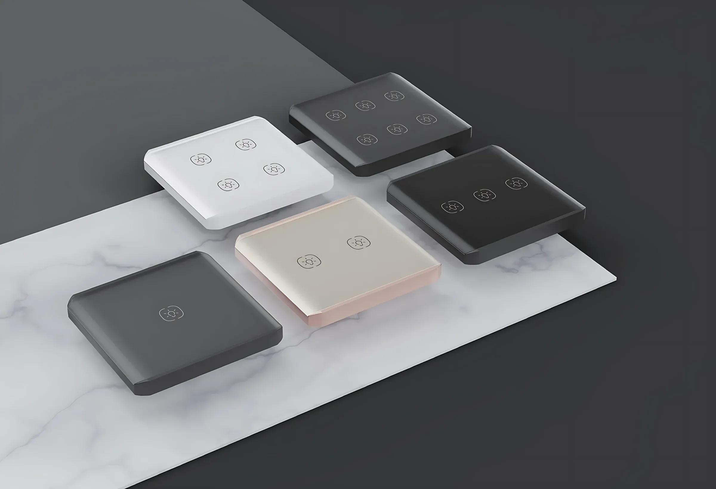 Square glass smart switches in five finishes laid on marble