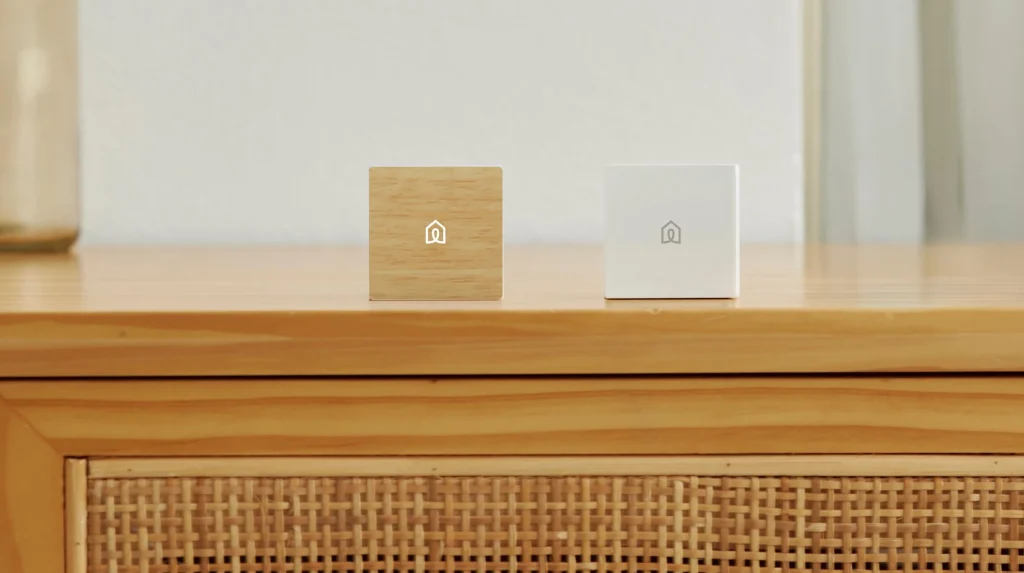 Wood and white cube remotes on a rattan sideboard